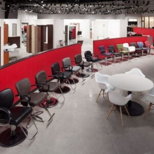 Kaemark A salon with chairs and tables in a red room.