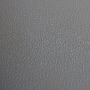 Kaemark A close up image of a gray leather surface.