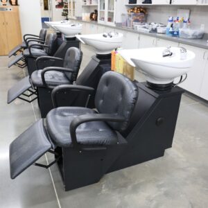 Kaemark A hair salon with several chairs and sinks.