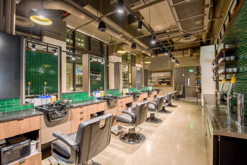 Kaemark A barber shop with green tiled walls and chairs.