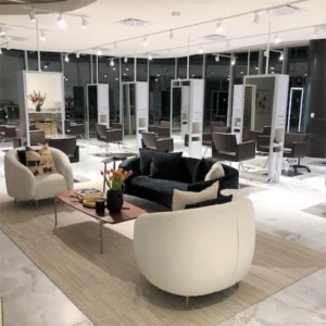 Kaemark A salon with chairs, couches and mirrors.