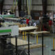 Kaemark Cnc machines in a factory with people working on them.