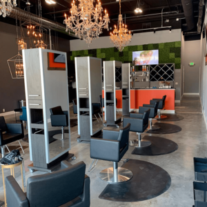 a hair salon that has been kaemark furnished with styling stations and styling chairs