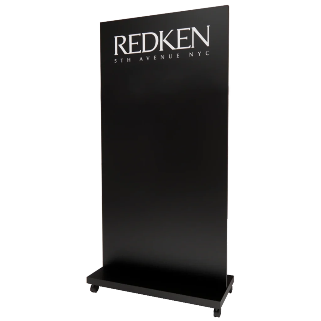 Kaemark A redken stand with a black logo on it.